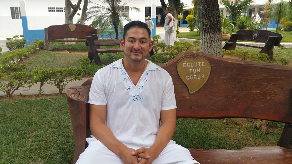 Will Arredondo seated on a bench in a garden